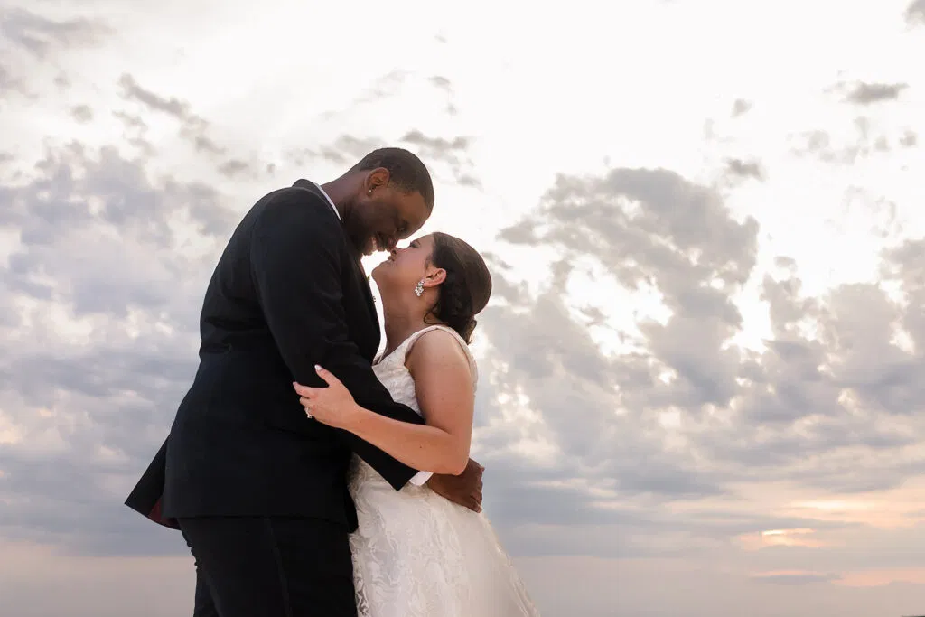 Romantic bride and groom embracing at sunset on Tulum beach - destination wedding photography in Mexico