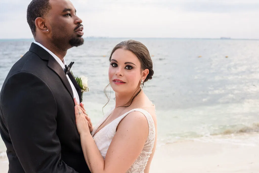 Elegant bride and groom embracing on pristine Tulum beach during romantic destination wedding photography session